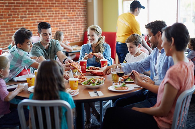 Happy Peter Piper Pizza customers enjoying their delicious meal